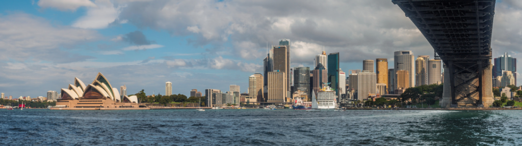 Photo of the Sydney skyline taken from under the Harbour Bridge