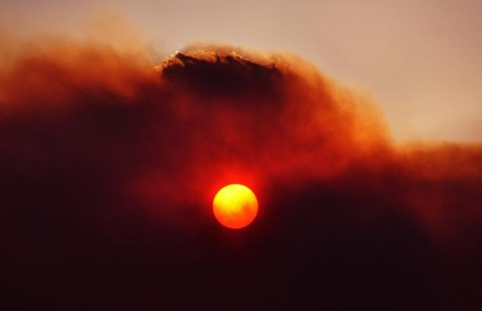 Photo of a hazy and cloudy red sunset