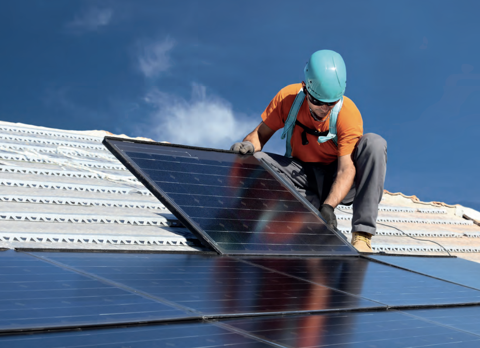 Photo of a man installing solar panels