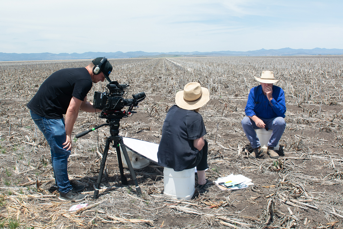 A photo of a farmer on farm being photographed