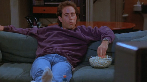 Photo of Kramen from Seinfield eating popcorn on a couch