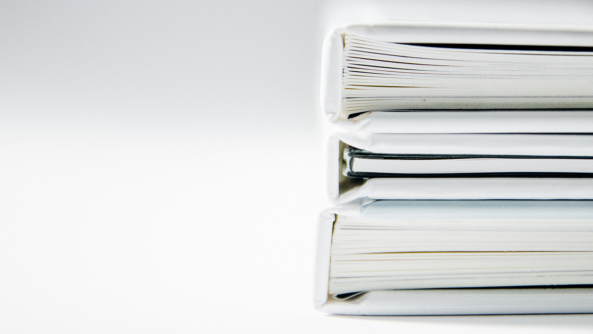 Photograph of a stack of white folders