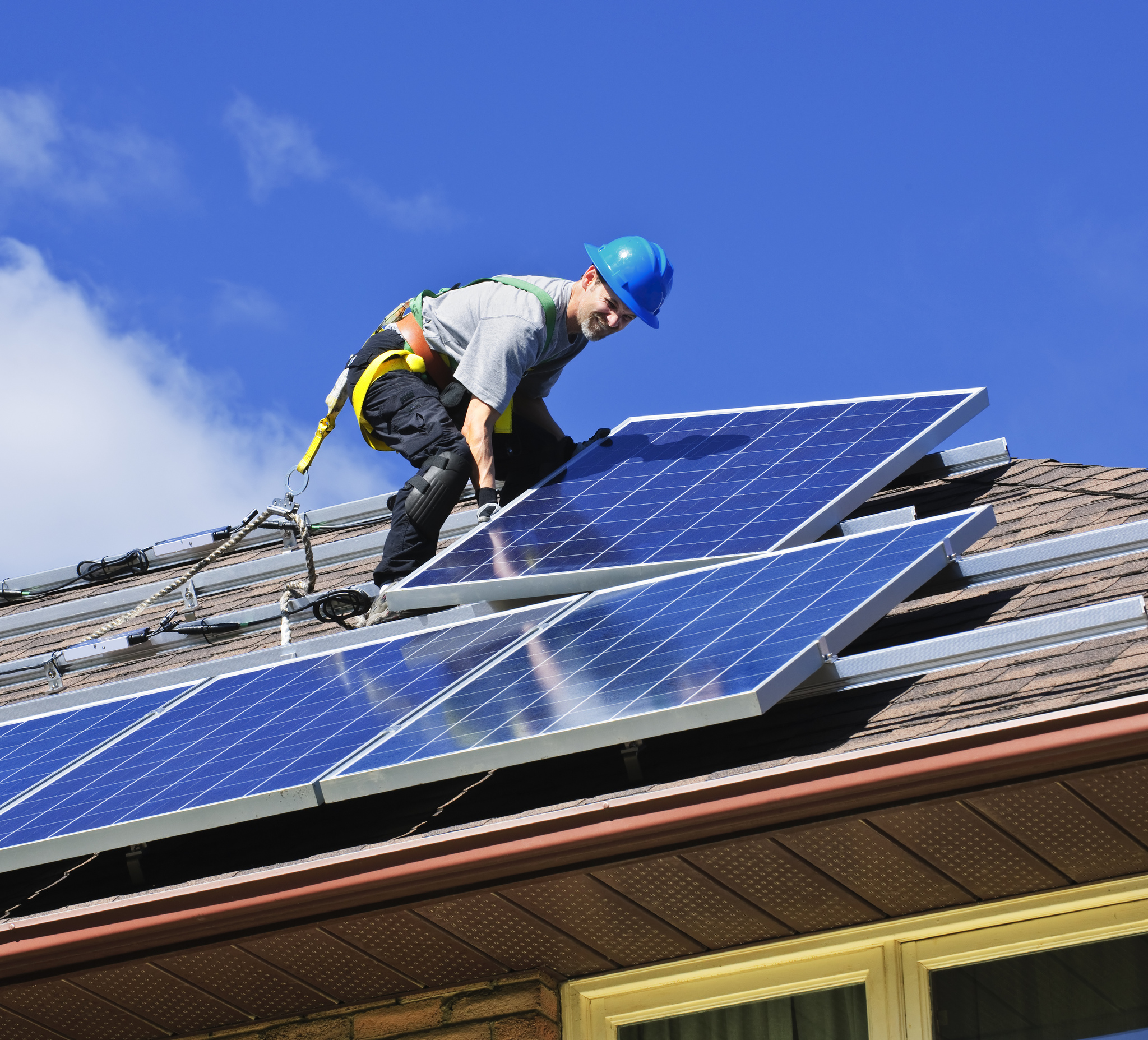 A photo of a rooftop solar installer