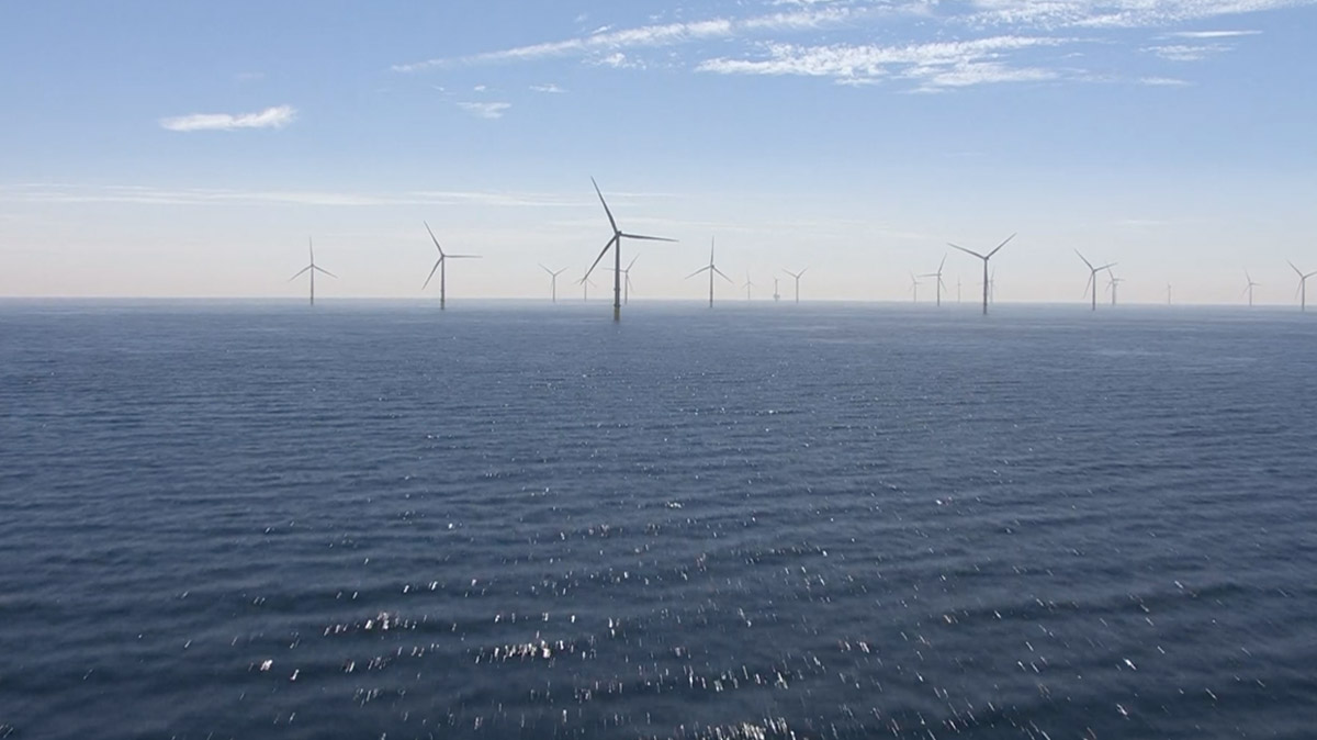 An image of wind turbines in the ocean off the coast of Grimsby, England.