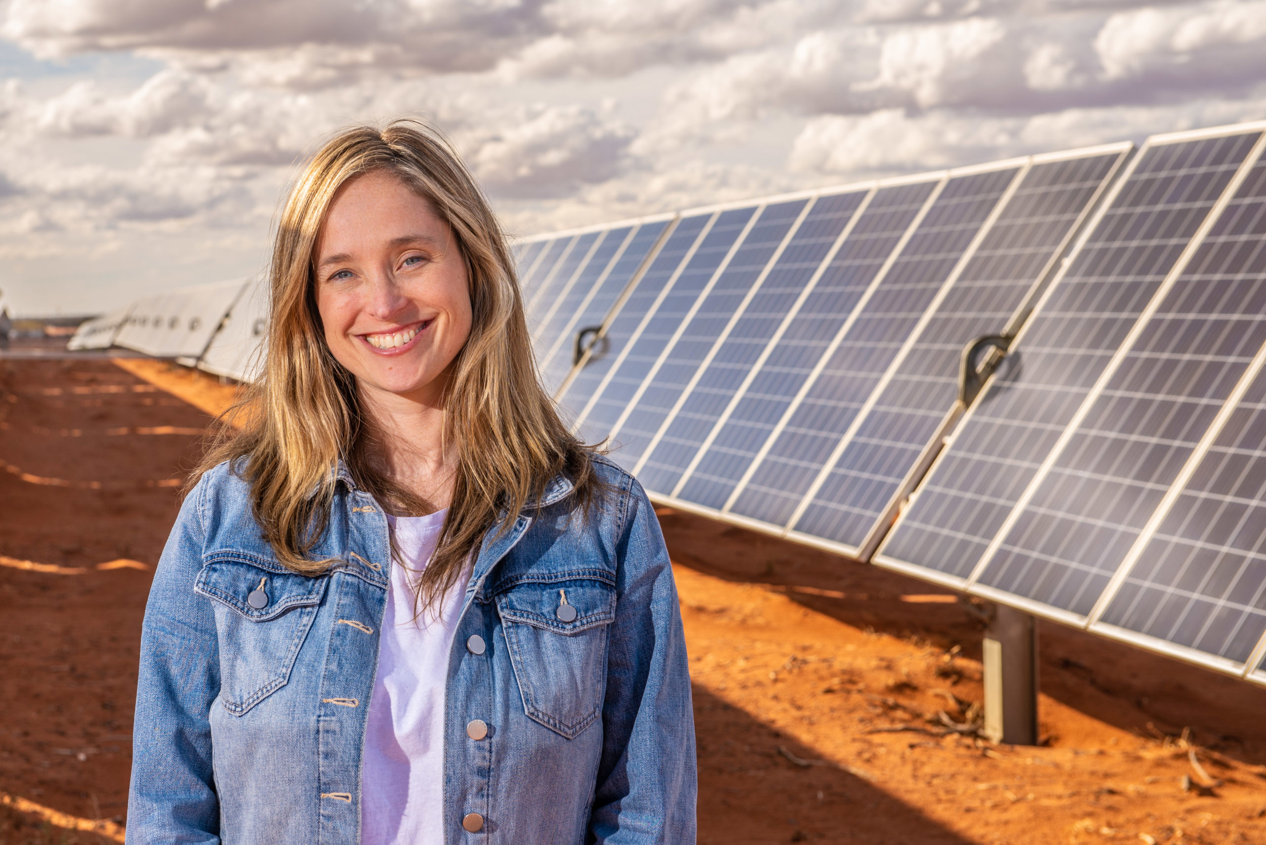 Amanda Mckenzie in front of solar panels