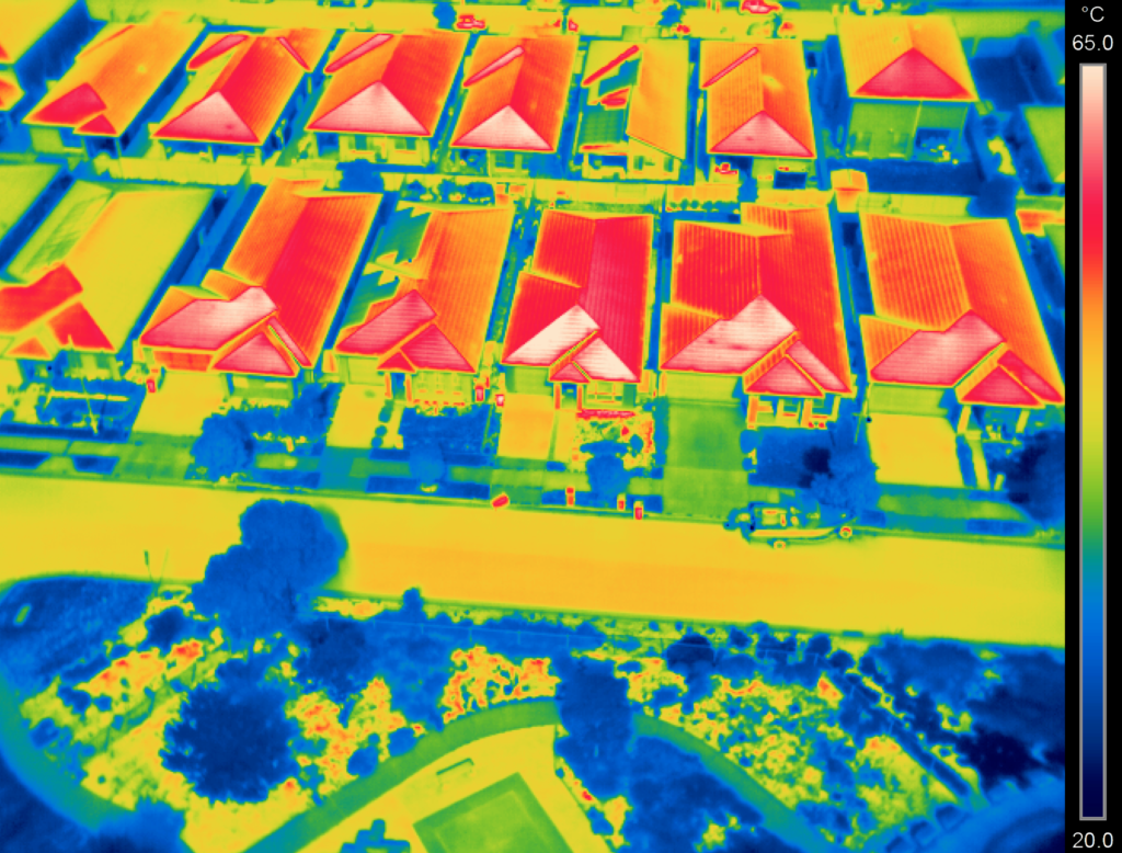 The temperature reflecting off rooftops in Jordan Springs, an area suffering from the urban heat island effect. A scale at right represents the highs and lows, with rooftops reaching 65 degrees celsius